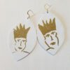 A pair of earrings with gold faces and crowns.