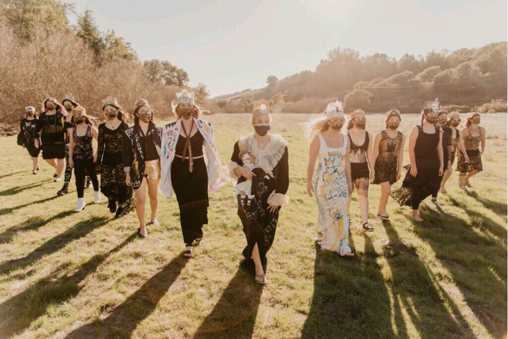 A group of people walking in the grass.